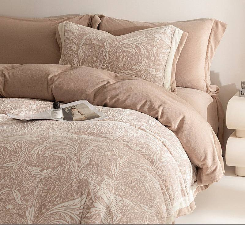 Neatly made bed with patterned bedding and pillows in a bedroom setting.