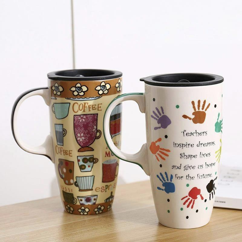 Two mugs on a wooden surface with one featuring coffee-themed designs and the other with handprints and text.