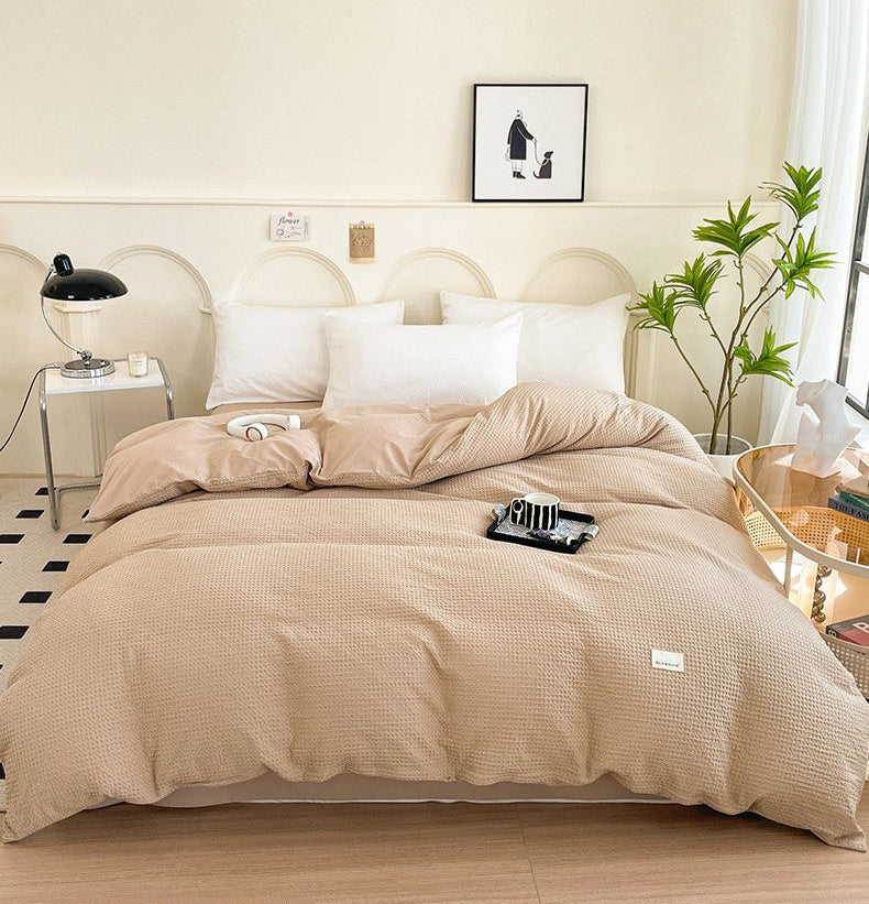 Beige quilt cover on a bed in a bedroom setting with text 'Soft-Enjoy the dream of patience'.