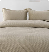 Beige textured bedding set with pillows on a white background, featuring text about anti-static silk skin care.