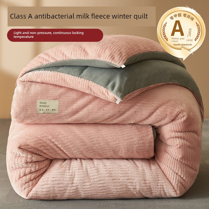 Pink antibacterial milk fleece winter quilt with green lining on a neutral background