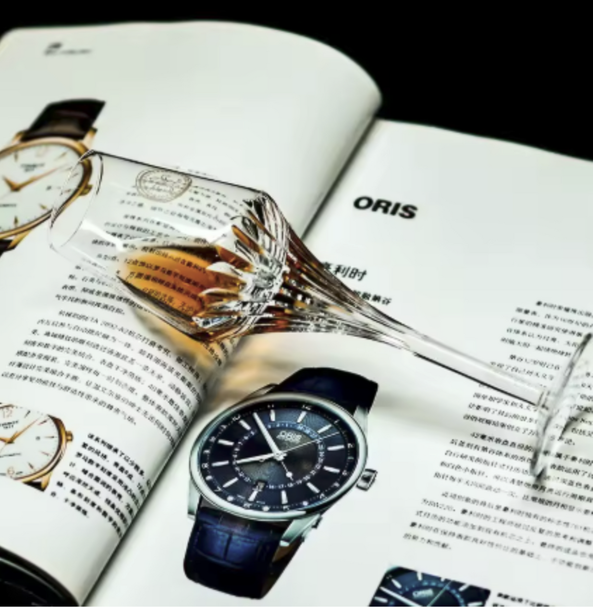 Oris watch displayed on an open magazine with a glass of whiskey