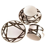 Ceramic tea set with black geometric patterns on a white background