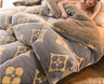 Fluffy gray and beige patterned blanket on a bed with a person holding it, and 'Rapid delivery' logo.