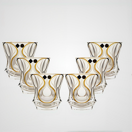 Set of six decorative glass tumblers with gold and black patterns on a white background
