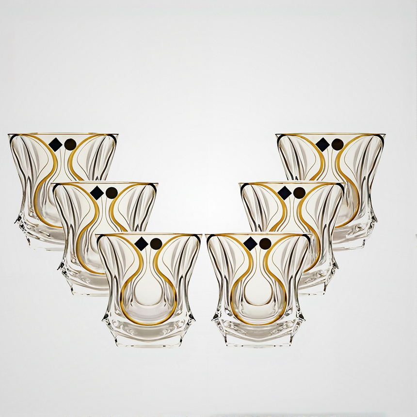 Set of six decorative glass tumblers with gold and black patterns on a white background