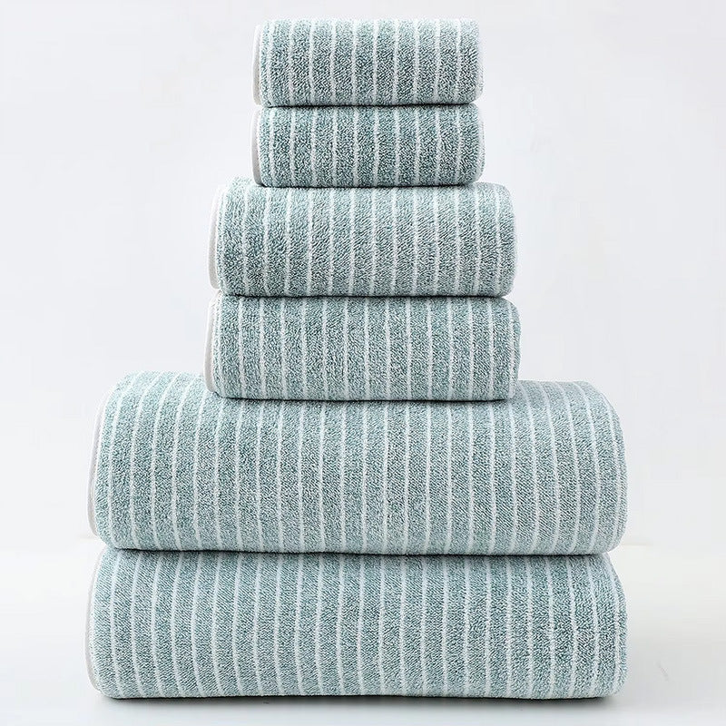 Stack of green striped towels on a white background