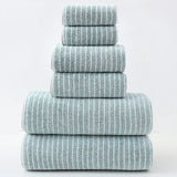 Stack of green striped towels on a white background