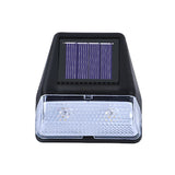 Solar-powered outdoor light with visible solar panel on a white background