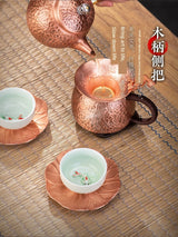 Copper teapot and cups on a wooden surface with text overlay