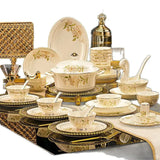 Dining set with gold and beige crockery on a white background