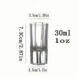 Clear glass shot glass with measurements on a white background