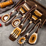 Set of wooden kitchen utensils on a gray surface with a wooden tray.
