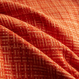 Close-up of orange fabric with a subtle pattern