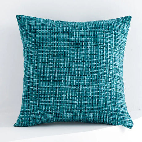 Teal textured pillow on a white background
