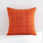 Orange textured pillow on a white background