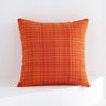 Orange textured pillow on a white background