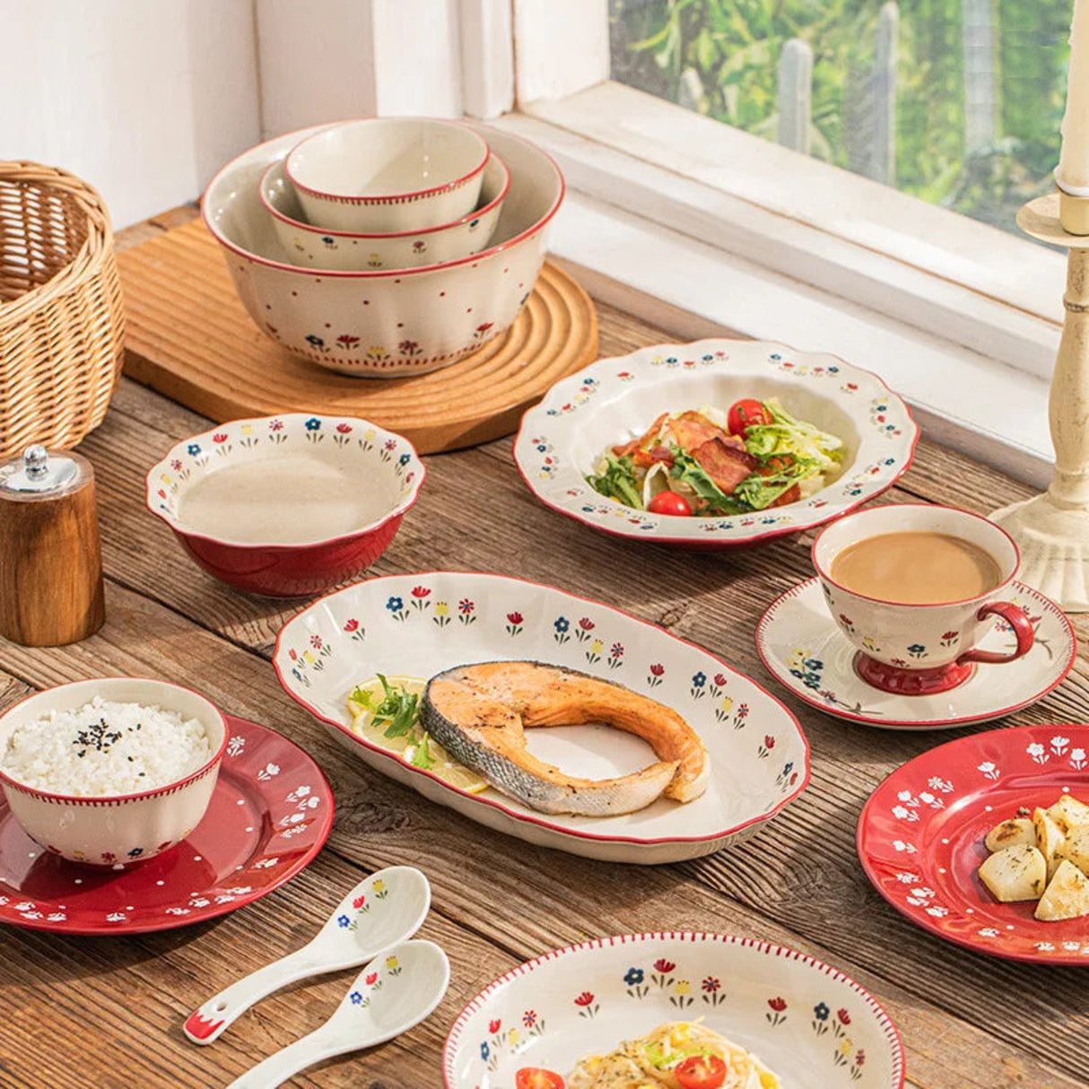 Ceramic tableware set with floral patterns on a wooden table.