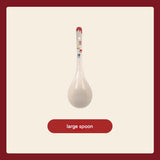 White ceramic spoon with floral design on a beige background