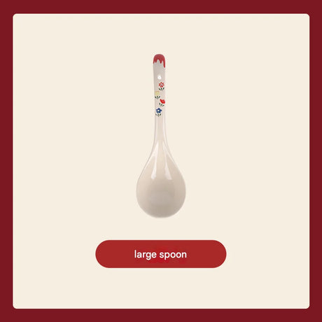 White ceramic spoon with floral design on a beige background