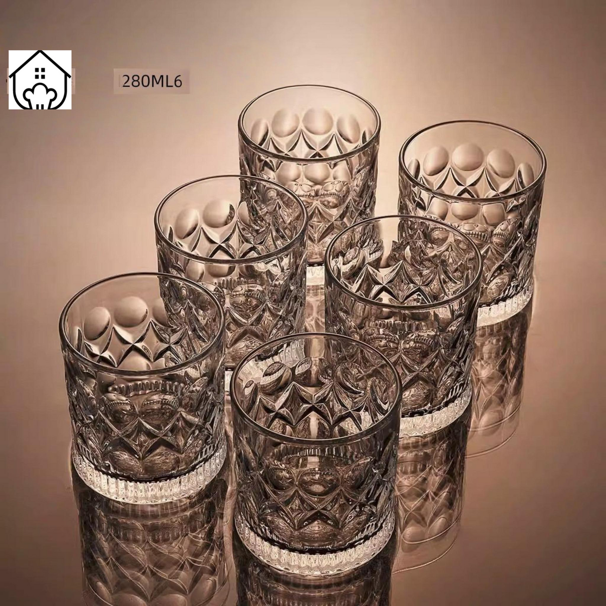 Set of six patterned glass tumblers on a reflective surface with a beige background.