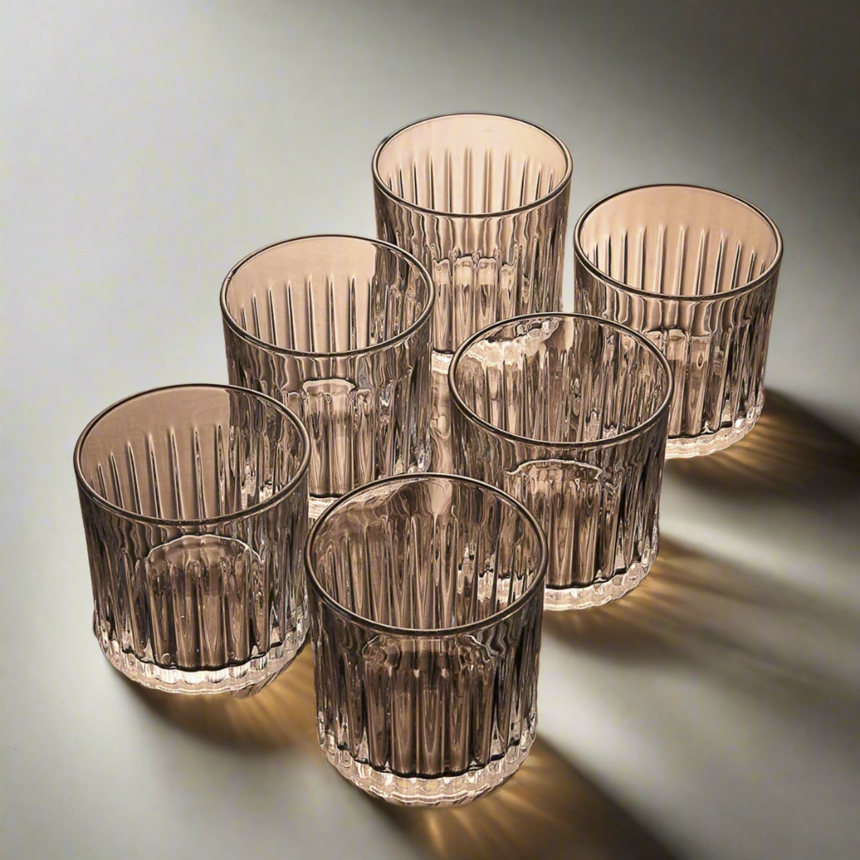 Set of six ribbed glass tumblers on a gradient background